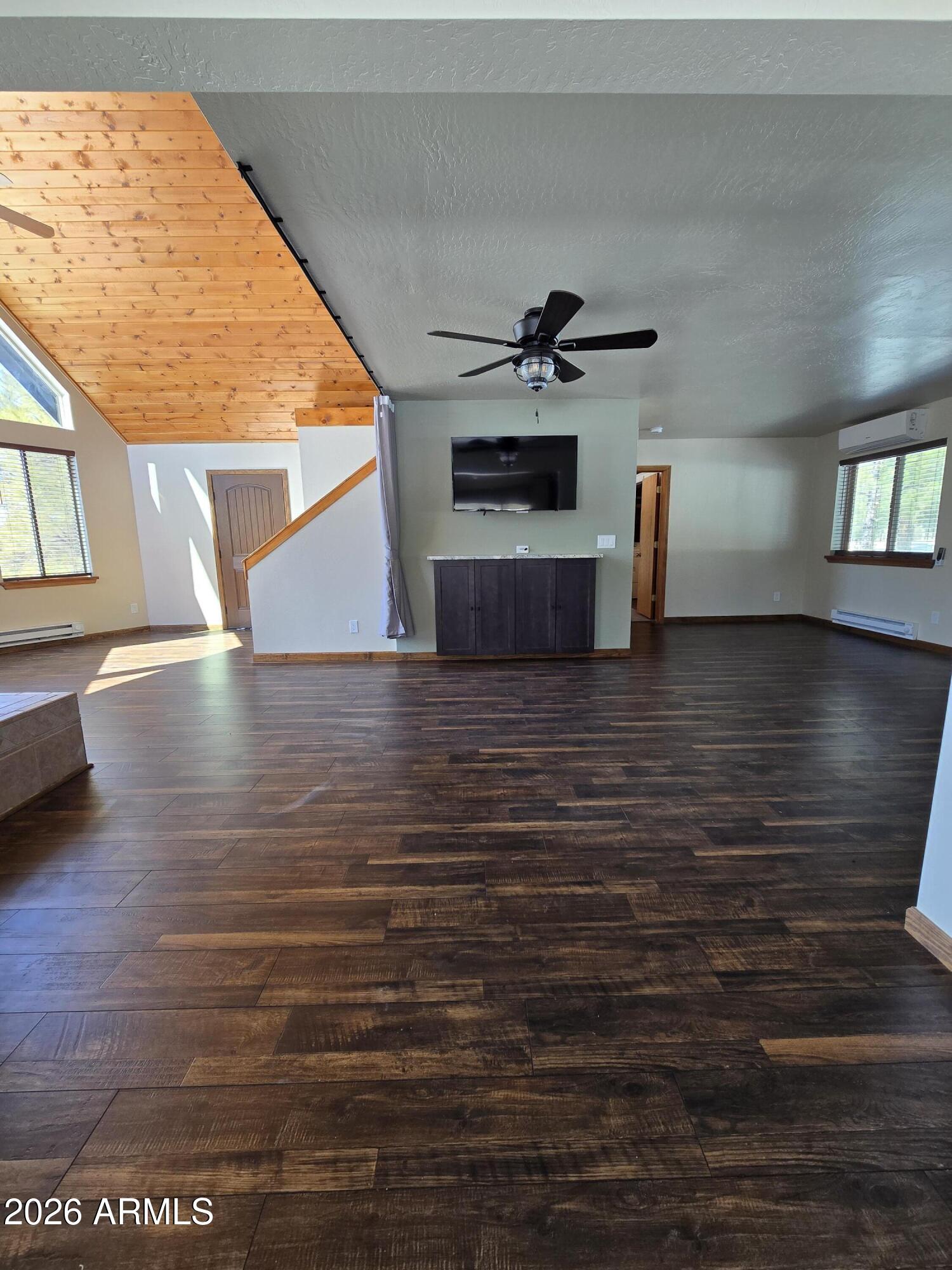 2795 Coyote Ridge Happy Jack, AZ 86024 - Photo 11 of 31 a view of empty room with wooden floor and windows