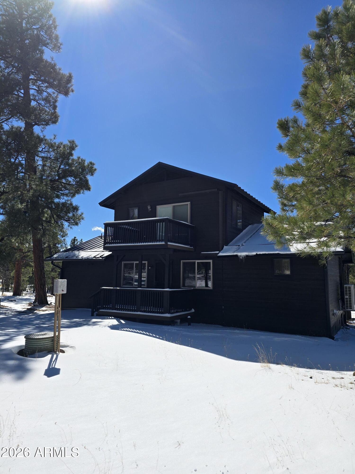 2795 Coyote Ridge Happy Jack, AZ 86024 - Photo 26 of 31 a front view of a house with a yard