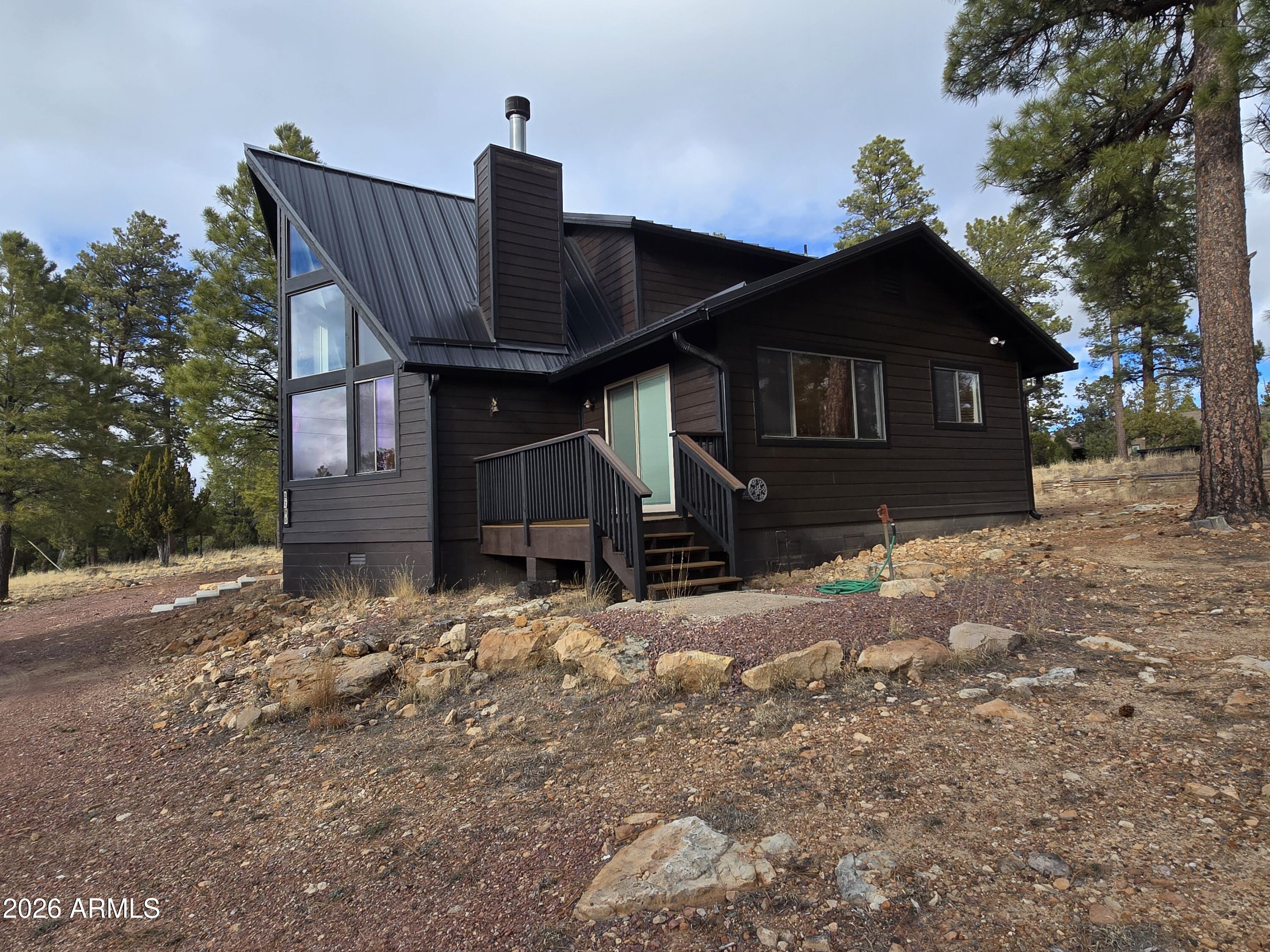 2795 Coyote Ridge Happy Jack, AZ 86024 - Photo 27 of 31 a view of a house with a yard