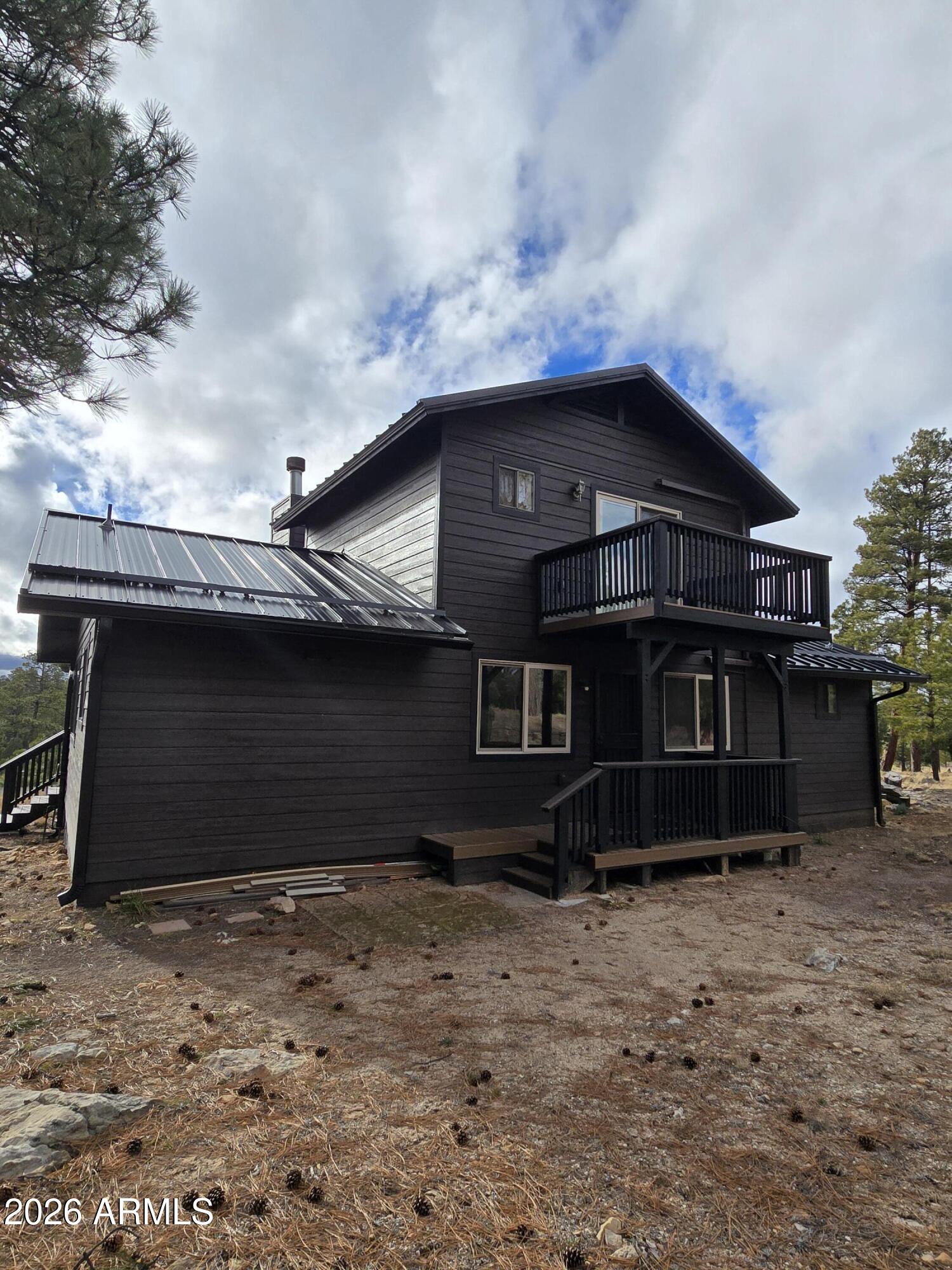 2795 Coyote Ridge Happy Jack, AZ 86024 - Photo 29 of 31 a front view of a house with a yard