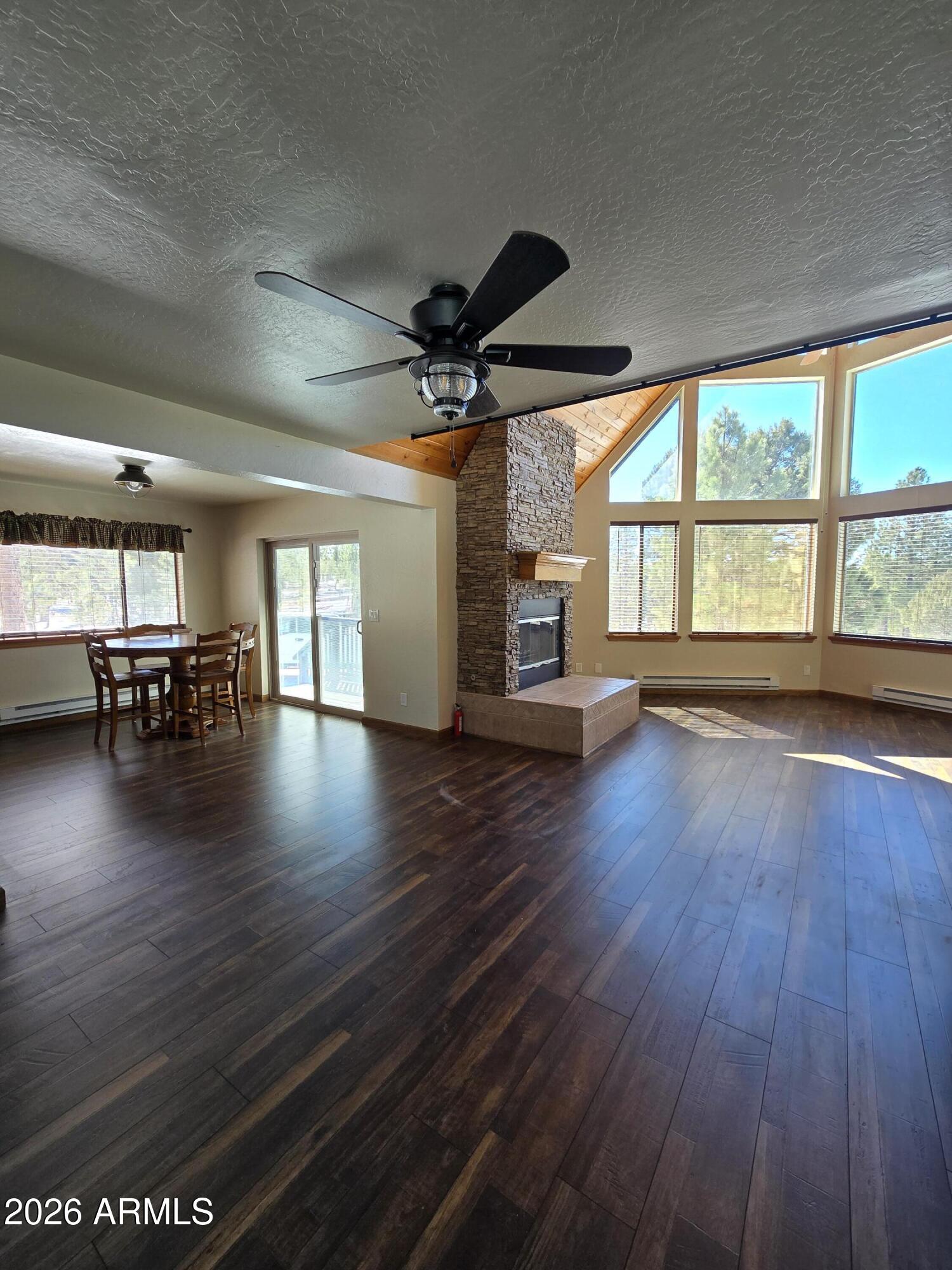 2795 Coyote Ridge Happy Jack, AZ 86024 - Photo 3 of 31 a view of a livingroom with furniture hardwood floor ceiling fan and windows