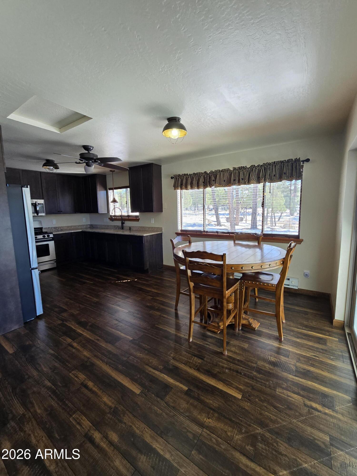 2795 Coyote Ridge Happy Jack, AZ 86024 - Photo 4 of 31 a view of a dining room with furniture window and wooden floor