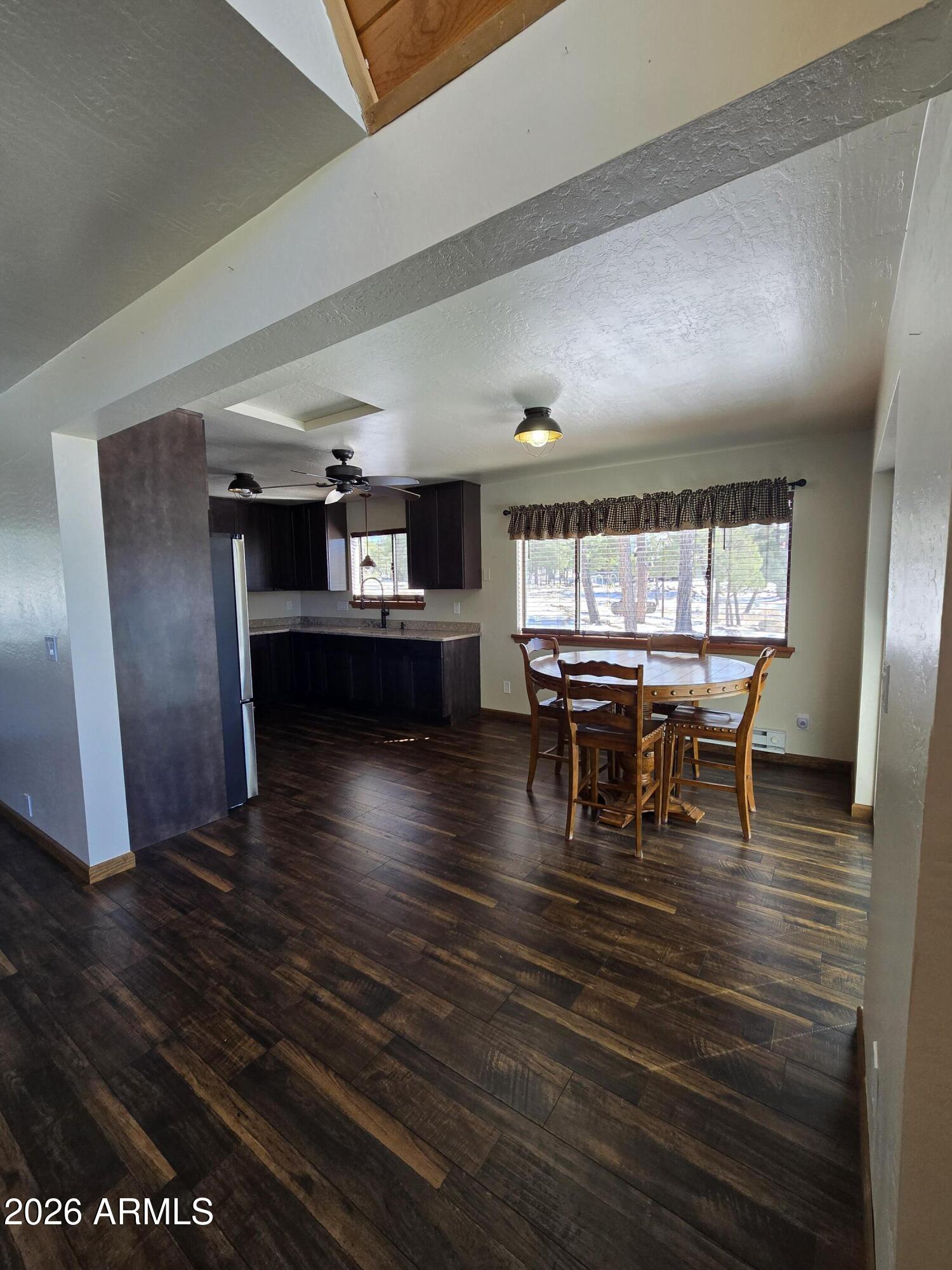 2795 Coyote Ridge Happy Jack, AZ 86024 - Photo 9 of 31 a dining room with furniture and wooden floor