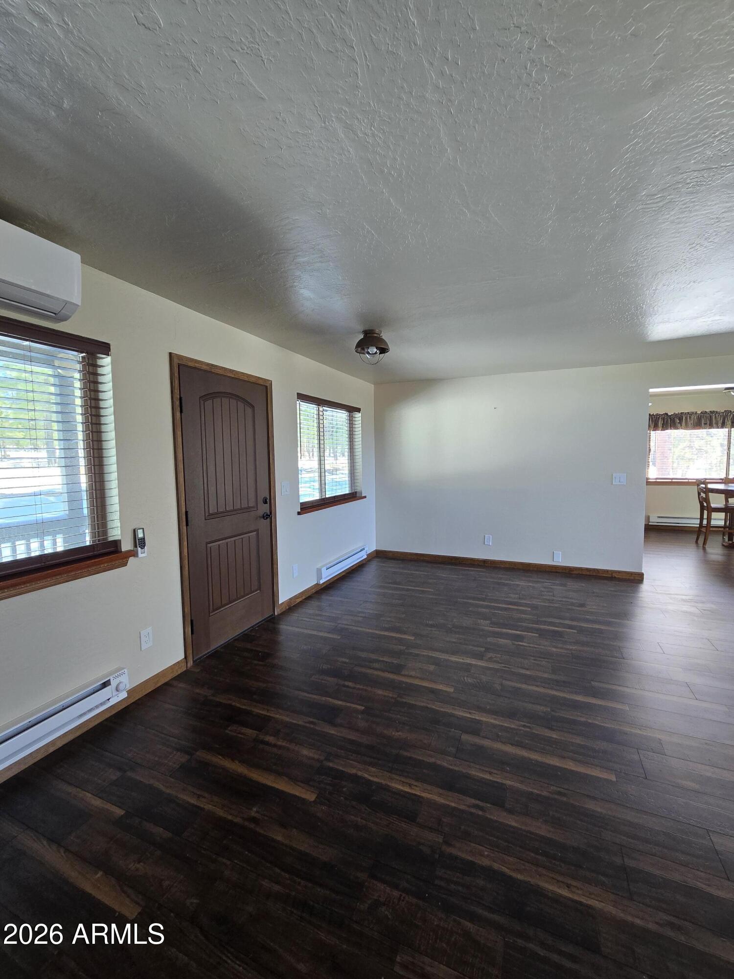 2795 Coyote Ridge Happy Jack, AZ 86024 - Photo 10 of 31 a view of an empty room with wooden floor and windows