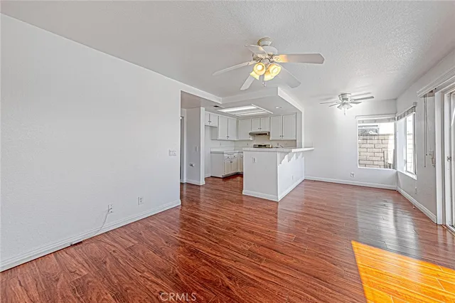 a view of a kitchen with wooden floor and a kitchen