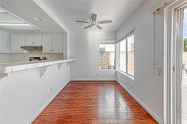 a view of a kitchen with a sink cabinets and wooden floor