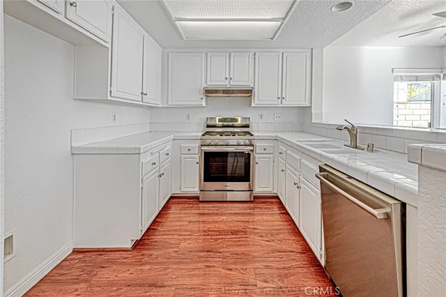 a kitchen with stainless steel appliances granite countertop a stove and a sink