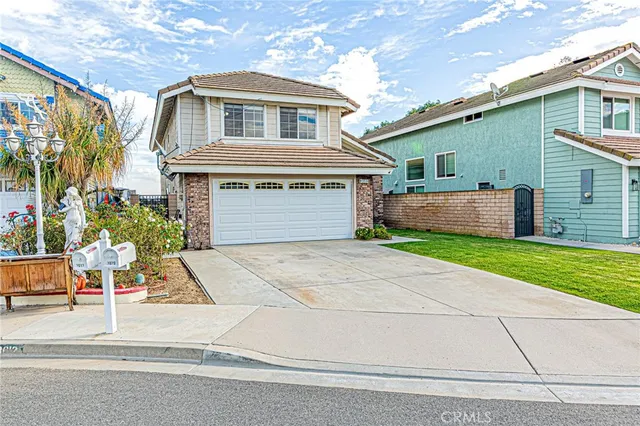 a front view of a house with a yard and a garage