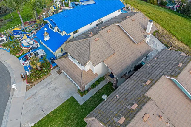 an aerial view of a house with a yard