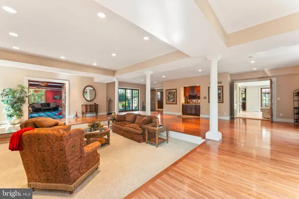 a dining room with furniture a fireplace and wooden floor