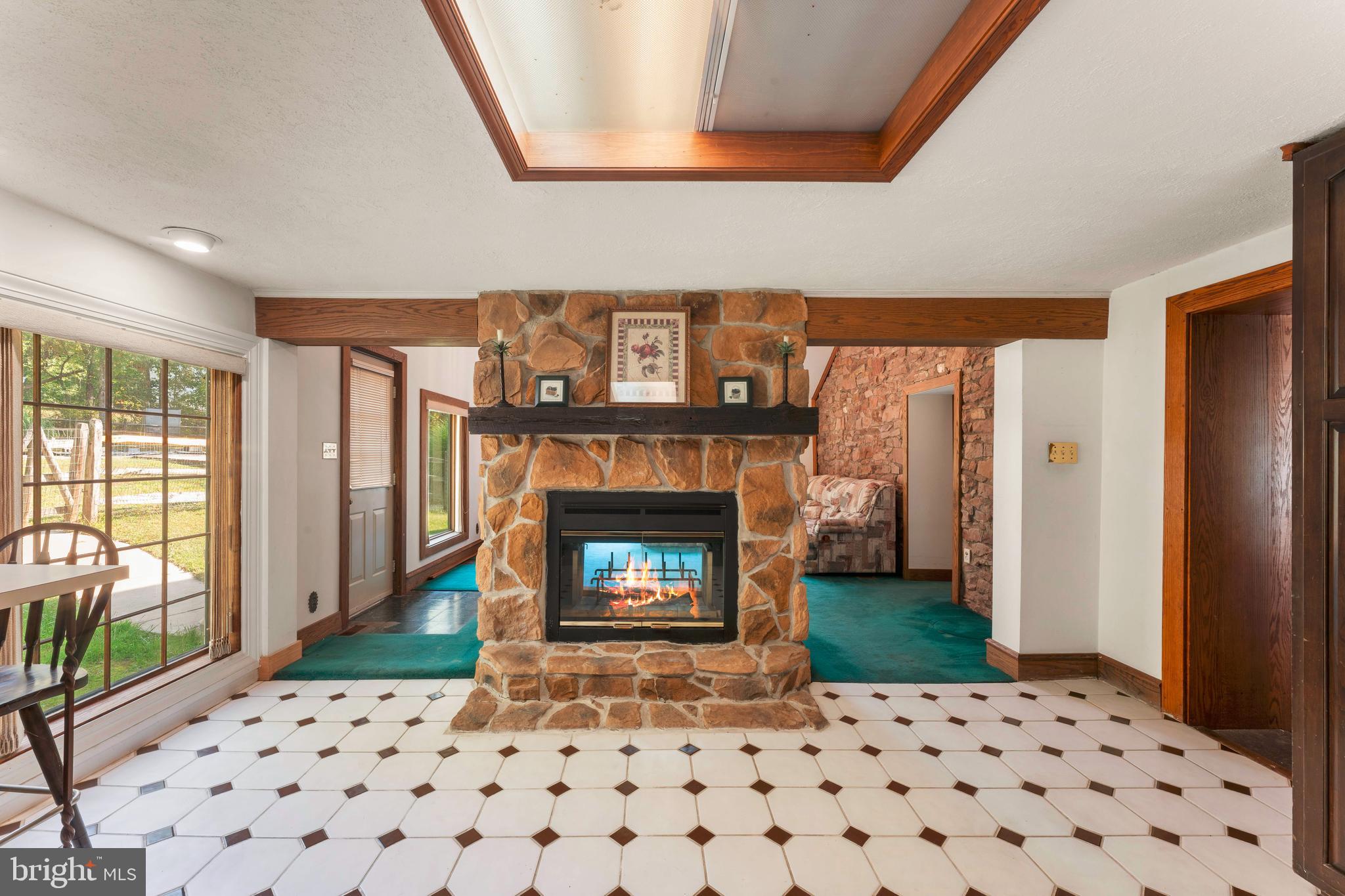 1390 Old Jacksonville Road Ivyland, PA 18974 - Photo 31 of 69 a living room with a fireplace and a large window