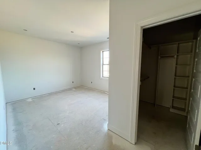 a view of large kitchen with granite countertop stainless steel appliances cabinets a sink and a wooden floor
