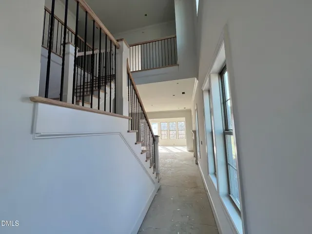 a view of staircase with railing and white walls