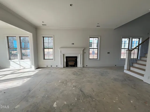 a kitchen with stainless steel appliances granite countertop a stove a sink a refrigerator a white stove and white cabinets