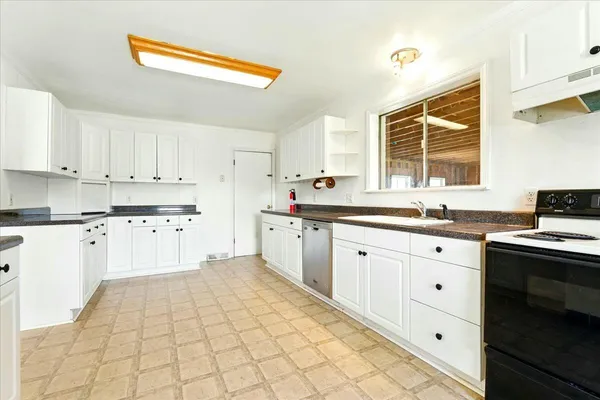 a kitchen with a sink stove and cabinets