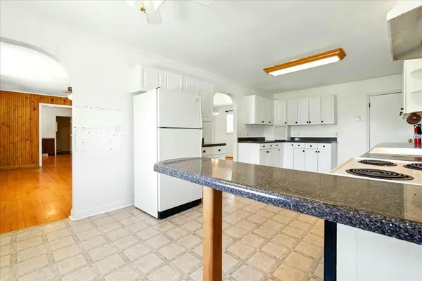 a kitchen with stainless steel appliances granite countertop a sink a stove and a refrigerator