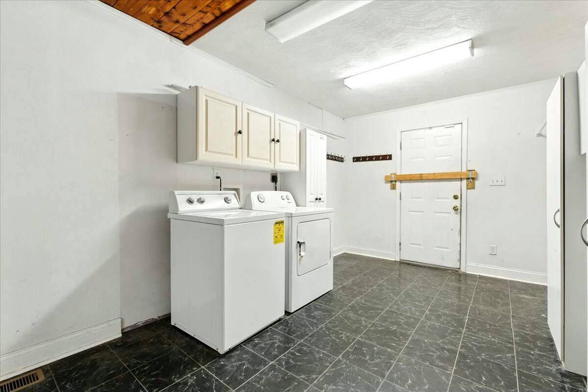 2351 Reese Mountain Road Elliston, VA 24087 - Photo 21 of 57 a utility room with cabinets washer and dryer
