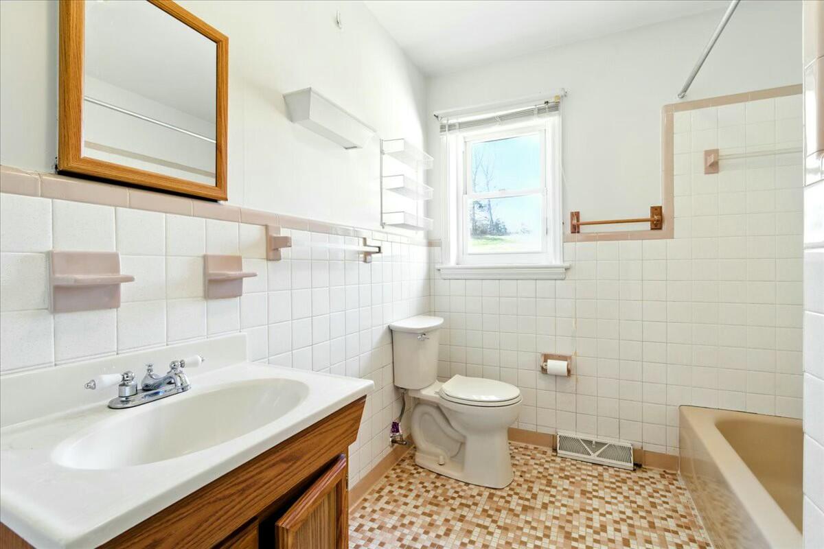 2351 Reese Mountain Road Elliston, VA 24087 - Photo 22 of 57 a bathroom with a sink toilet a mirror and shower
