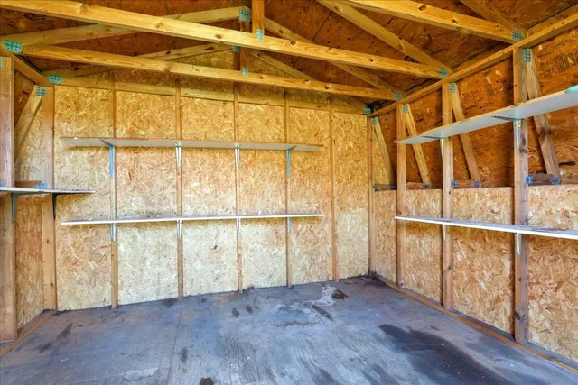 an aerial view of a house with yard and lake view