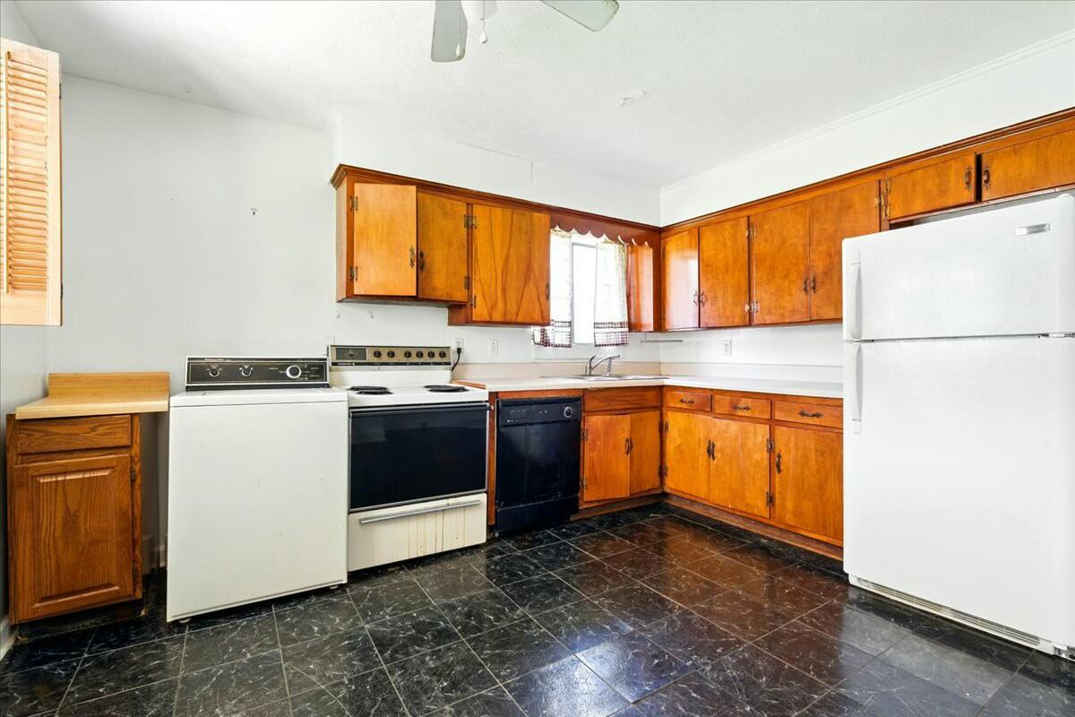 2351 Reese Mountain Road Elliston, VA 24087 - Photo 36 of 57 a kitchen with granite countertop a sink a window stainless steel appliances and cabinets