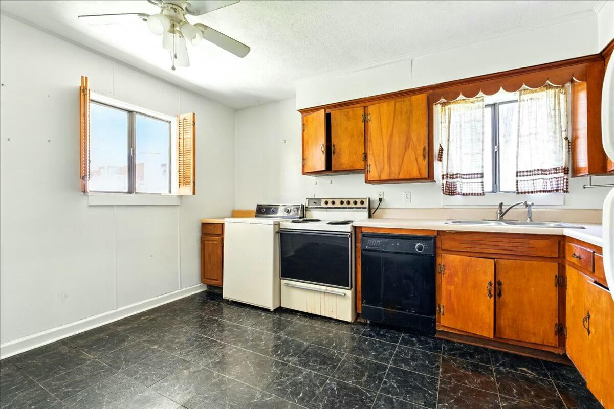 2351 Reese Mountain Road Elliston, VA 24087 - Photo 37 of 57 a kitchen with stainless steel appliances granite countertop a stove a sink and a microwave