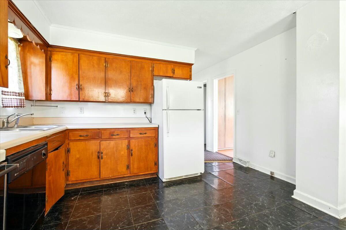 2351 Reese Mountain Road Elliston, VA 24087 - Photo 38 of 57 a kitchen with a refrigerator a sink and a stove