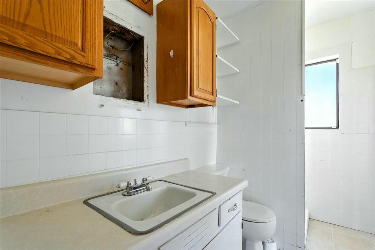 2351 Reese Mountain Road Elliston, VA 24087 - Photo 45 of 57 a bathroom with a sink toilet and mirror