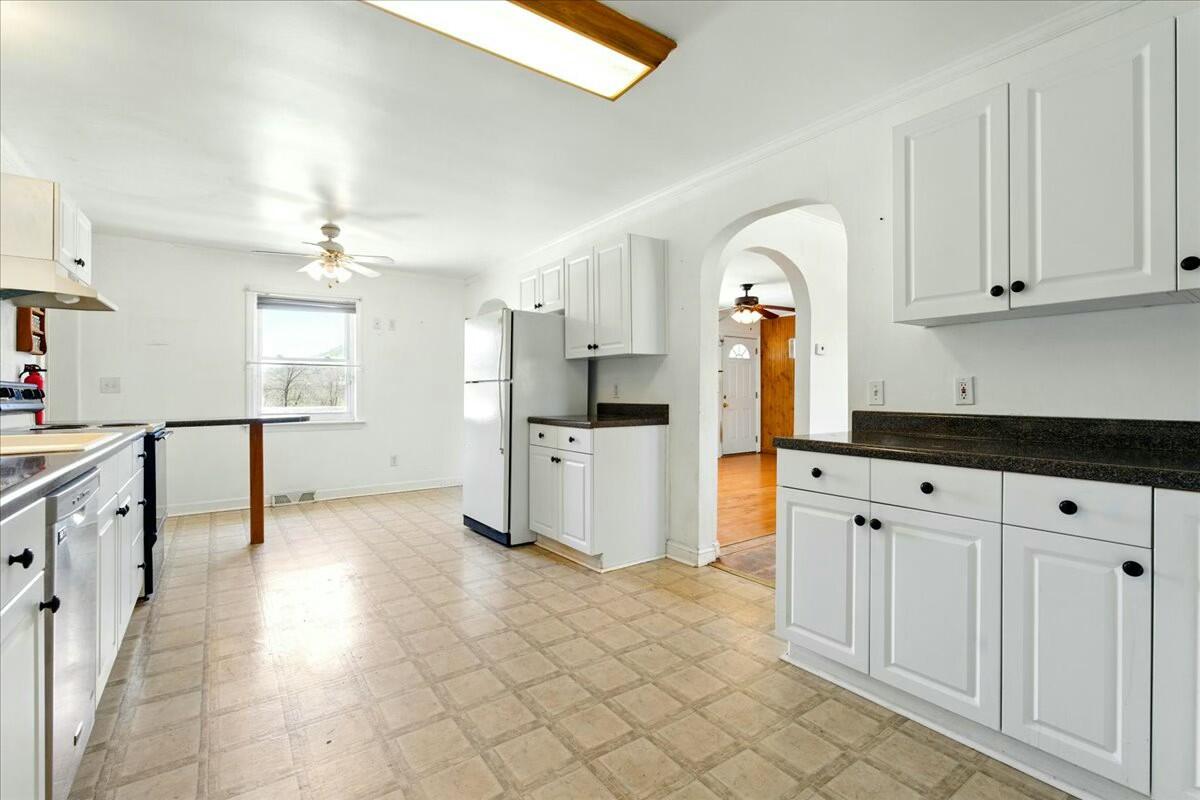 2351 Reese Mountain Road Elliston, VA 24087 - Photo 10 of 57 a kitchen with granite countertop a sink cabinets and stainless steel appliances