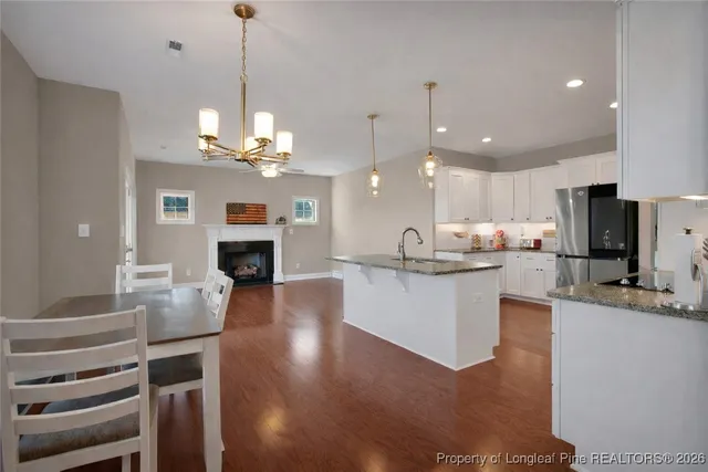 a bedroom with a large bed and a flat tv screen on dresser