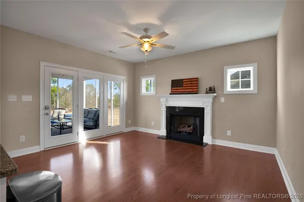 a white toilet sitting next to a bathroom sink vanity and granite