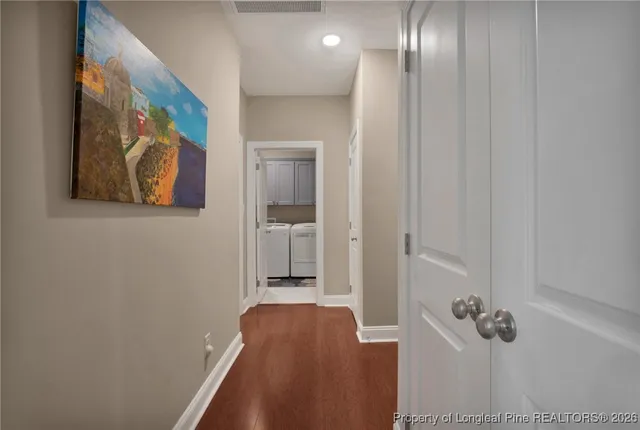 a bedroom with a large bed and a chandelier fan