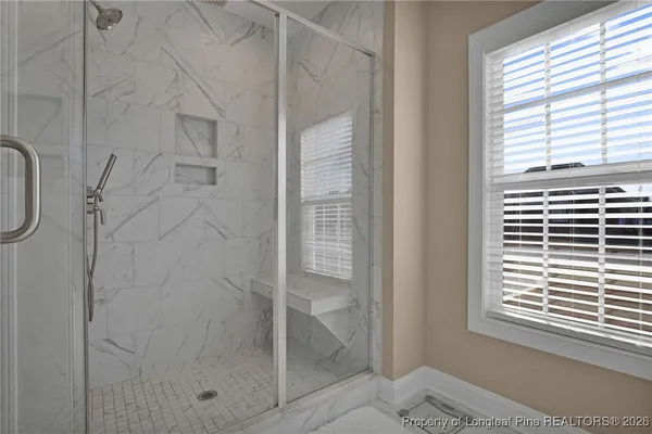 a en suite bathroom with a granite countertop sink and a mirror
