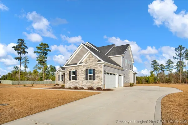 a front view of a house with a yard and garage