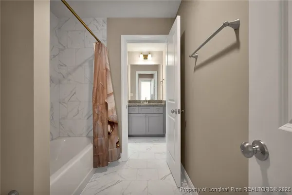 a en suite bathroom with a granite countertop sink and a mirror
