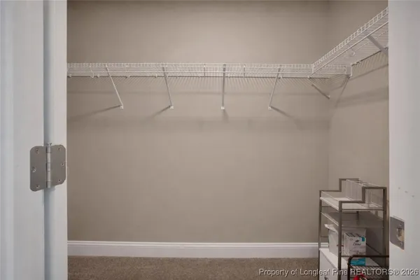 a dining room with furniture water view and a floor to ceiling window