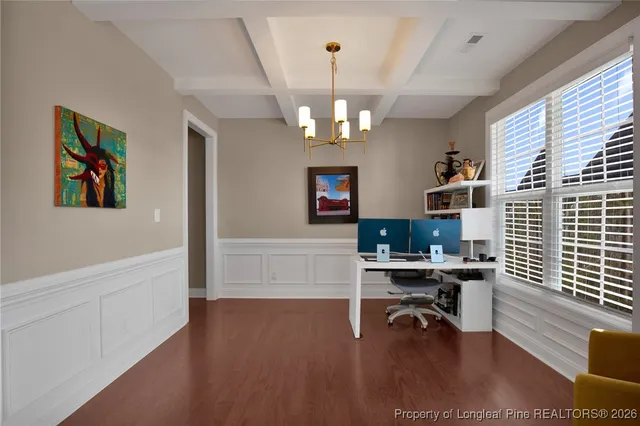 a kitchen with stainless steel appliances granite countertop a stove a sink a oven a dining table and chairs with wooden floor