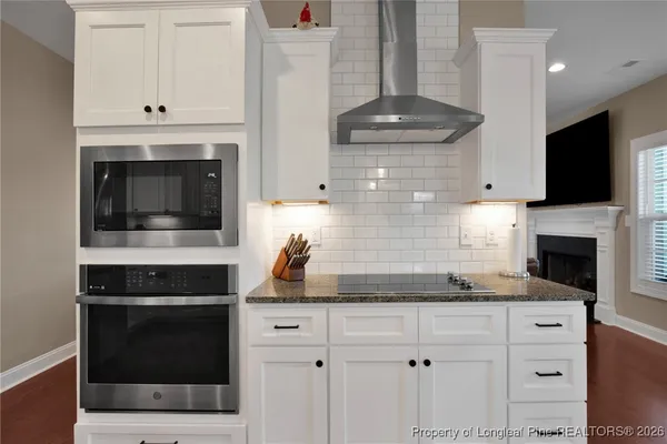 a large kitchen with a table and chairs