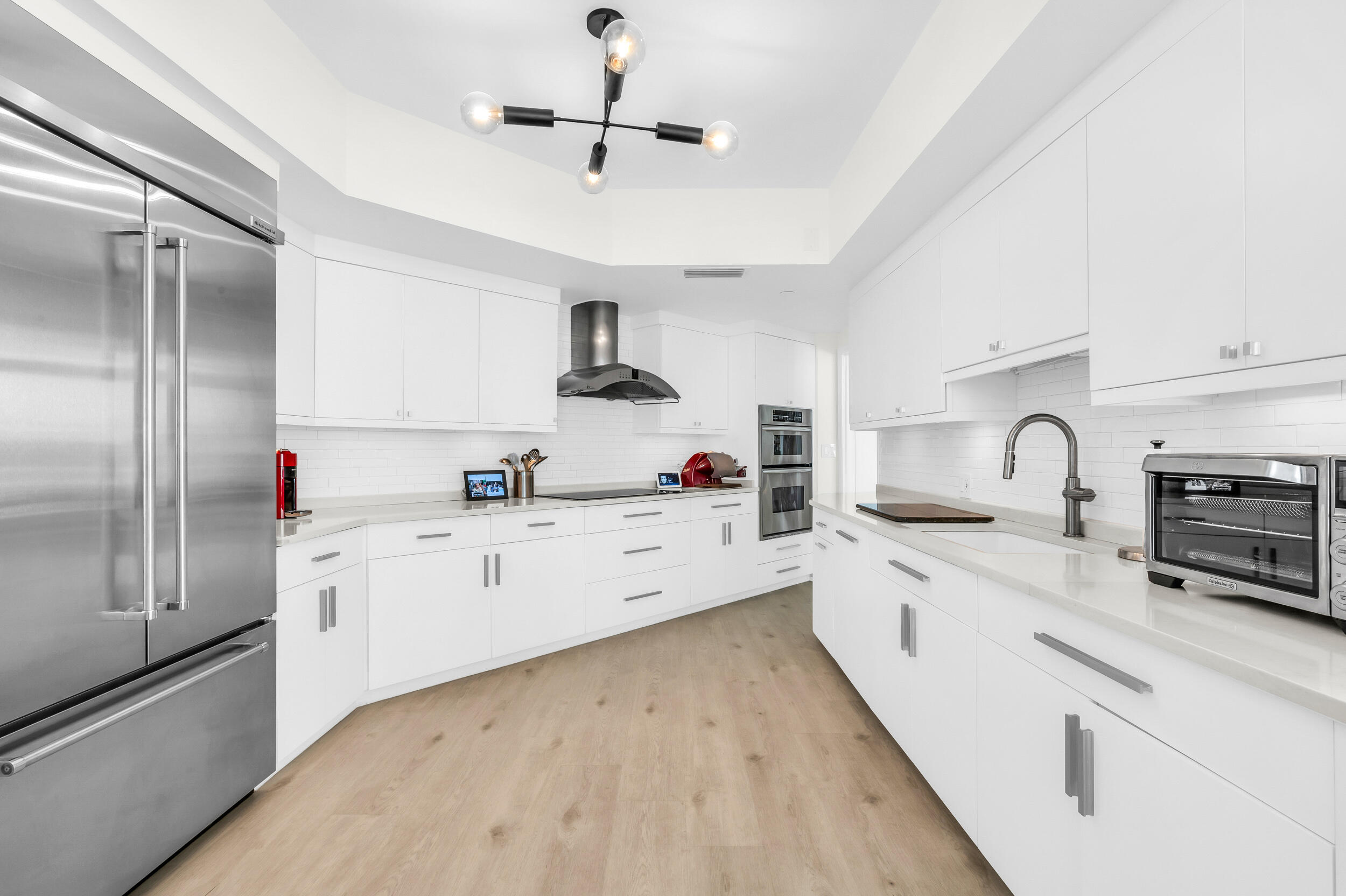 300 Southeast 5th Avenue, Unit 6110 Boca Raton, FL 33432 - Photo 16 of 96 a large white kitchen with stainless steel appliances granite countertop a sink a stove and refrigerator