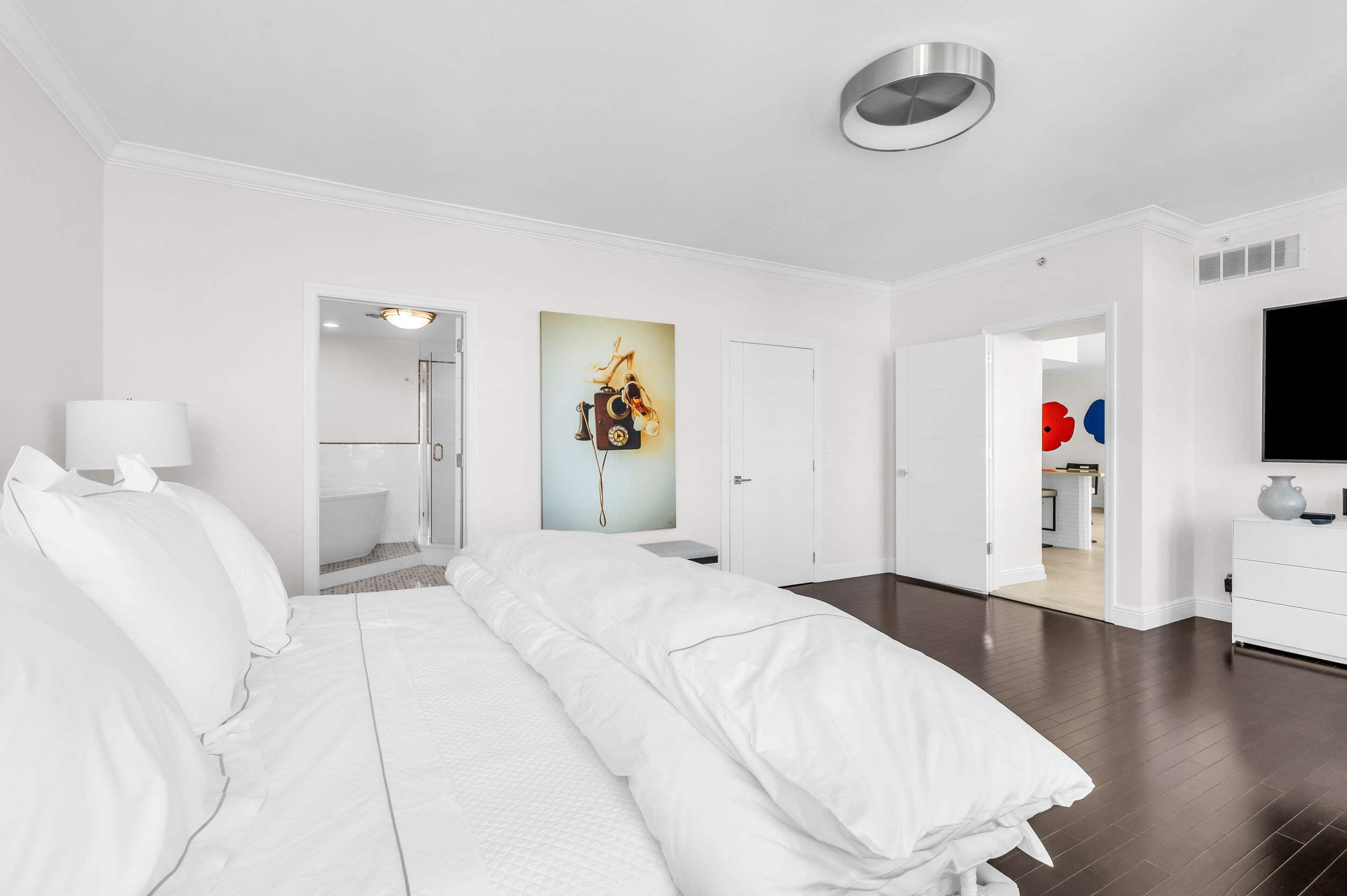 300 Southeast 5th Avenue, Unit 6110 Boca Raton, FL 33432 - Photo 36 of 96 a spacious bedroom with a bed and a flat screen tv