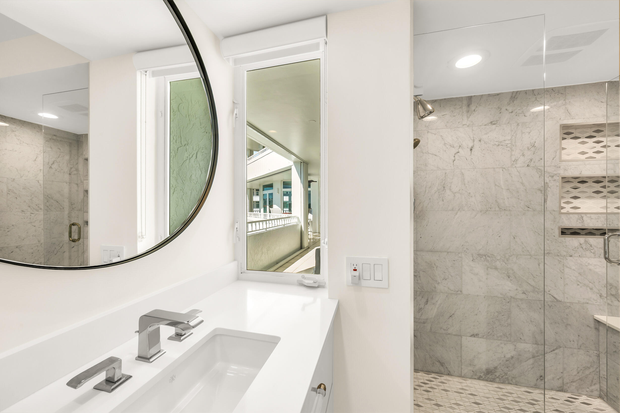 300 Southeast 5th Avenue, Unit 6110 Boca Raton, FL 33432 - Photo 7 of 96 a bathroom with a sink a mirror and a shower