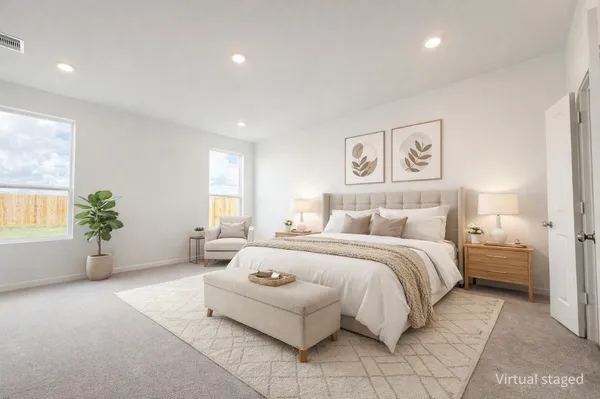 a spacious bedroom with a bed and a couch