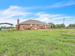a view of a house with a yard and sitting area