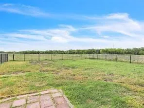 a view of a field with an ocean