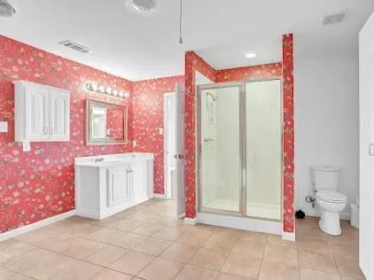 a bathroom with a sink mirror and toilet