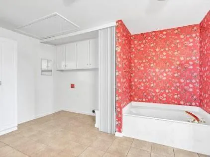 a bathroom with a bathtub and shower