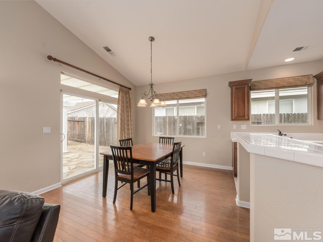 10592 Iron Point Circle Reno, NV 89521 - Photo 4 of 20 a view of a dining room with furniture window and wooden floor