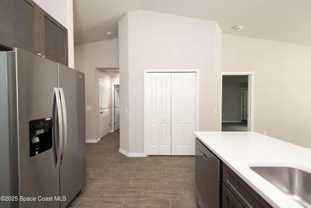 a kitchen with a refrigerator and countertop