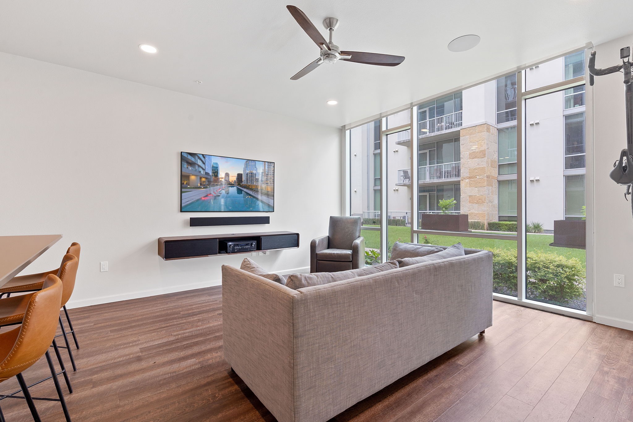 1600 Barton Springs Road, Unit 2102 Austin, TX 78704 - Photo 12 of 37 a living room with furniture a large window and wooden floor