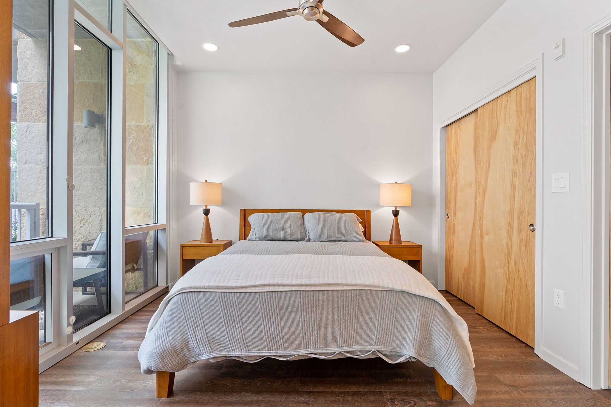 1600 Barton Springs Road, Unit 2102 Austin, TX 78704 - Photo 13 of 37 a spacious bedroom with a bed and wooden floor