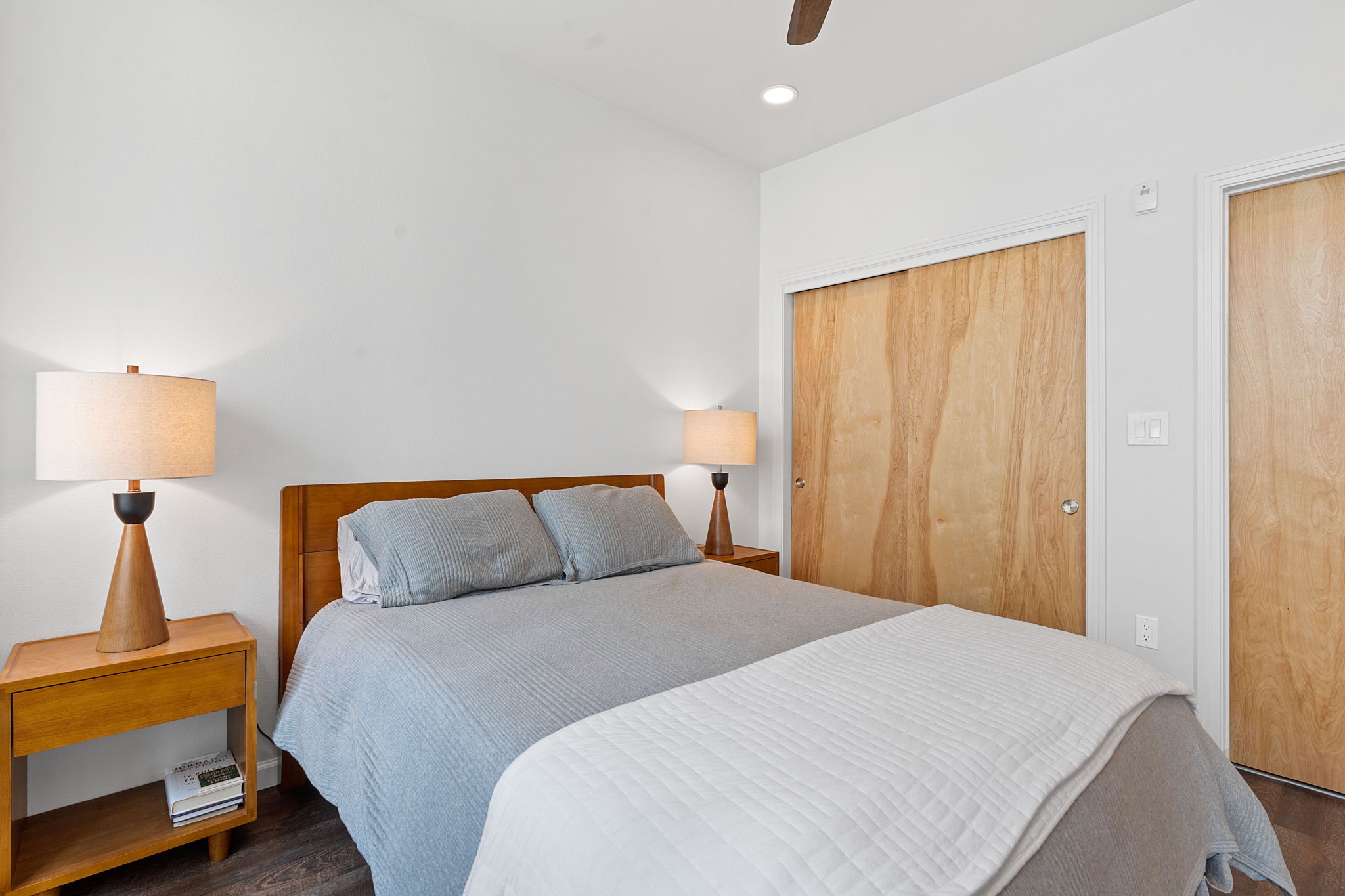 1600 Barton Springs Road, Unit 2102 Austin, TX 78704 - Photo 15 of 37 a bedroom with a bed and a lamp